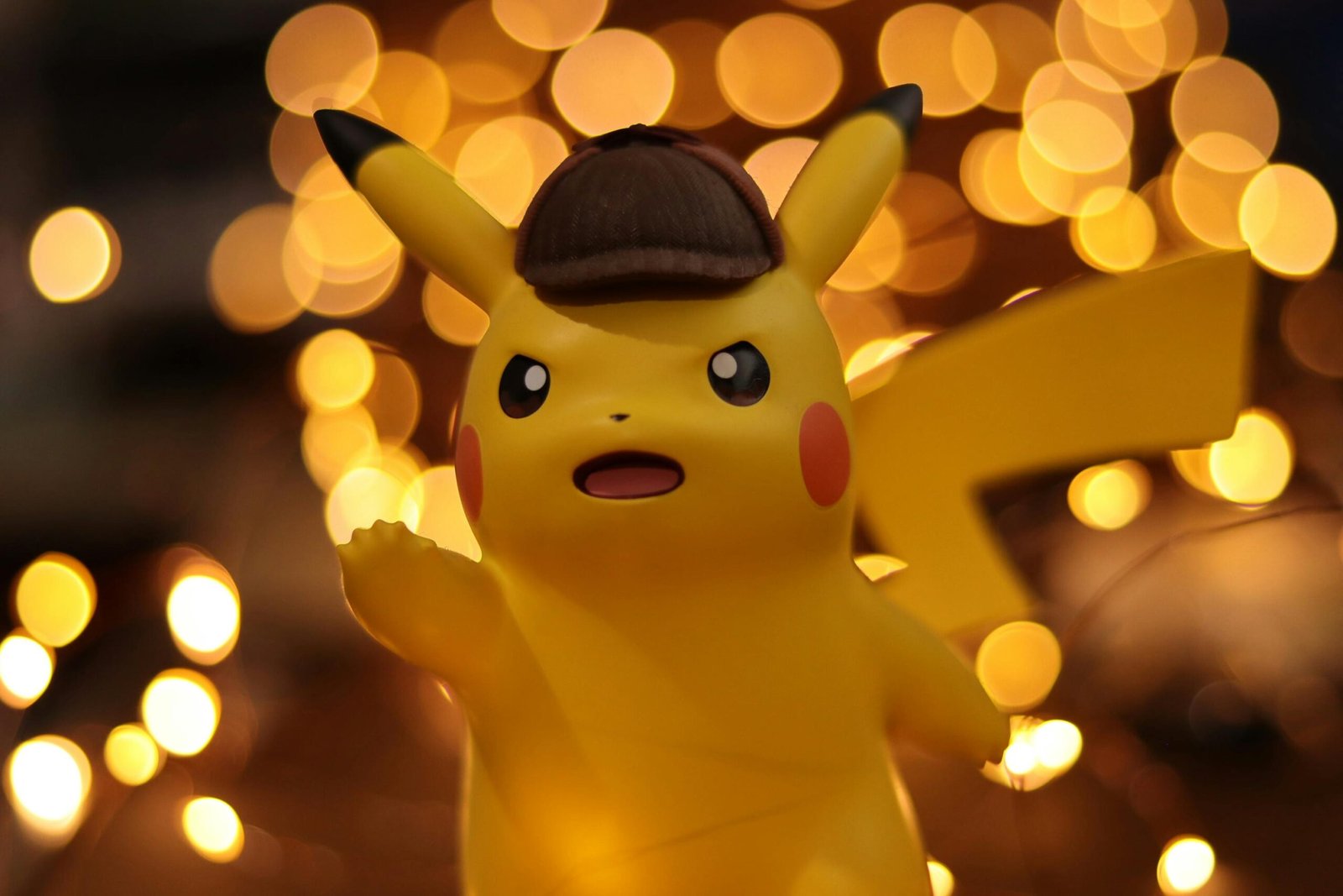 A close-up of a Pikachu figurine illuminated by a warm bokeh effect, creating an eye-catching visual.