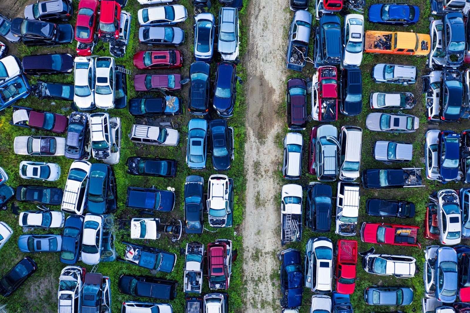 Aerial view of a car junkyard in Red Wing, MN, showcasing rows of parked vehicles.